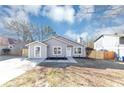 Charming one-story home featuring gray siding, a well-manicured yard, and a concrete driveway at 6042 Creekford Dr, Lithonia, GA 30058