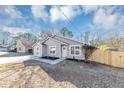 Charming one-story home featuring gray siding, a well-manicured yard, and a concrete driveway at 6042 Creekford Dr, Lithonia, GA 30058