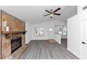 Inviting living room showcasing a stone fireplace, vaulted ceilings, and modern gray flooring at 6042 Creekford Dr, Lithonia, GA 30058