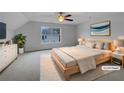 Cozy staged bedroom featuring soft carpet, a large window, and neutral decor at 641 Morningside Dr, Stockbridge, GA 30281