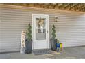 Cozy entrance featuring a decorative door, potted plants, and a charming welcome sign at 115 Bruce Rd, Douglasville, GA 30134