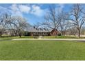 A beautiful single story house with a well-manicured lawn surrounded by flowering trees at 545 Highway 155 N, Mcdonough, GA 30253