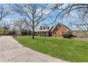 Charming single-story brick home featuring a well-maintained lawn and mature landscaping at 545 Highway 155 N, Mcdonough, GA 30253