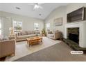 Bright living room with a vaulted ceiling, a stone fireplace, and large windows at 63 Avery Way, Dallas, GA 30157