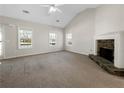 Spacious living room featuring a stone fireplace and large windows at 63 Avery Way, Dallas, GA 30157