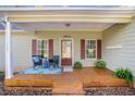 Inviting front porch with a sitting area and a 'Welcome' sign on the door at 305 Deep Step Rd, Covington, GA 30014