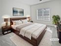 Relaxing main bedroom with large window, soft carpet, and neutral walls at 5692 Greensage Dr, Atlanta, GA 30349