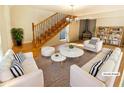 Bright living room with a fireplace, staircase, and neutral-colored furnishings at 949 Bobcat Se Ct, Marietta, GA 30067