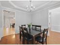 Formal dining room with hardwood floors, wainscoting, and a stylish chandelier at 1090 Fountain Head Ln, Lawrenceville, GA 30043