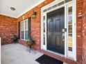 A welcoming front entryway with a classic black door and decorative planters at 1090 Fountain Head Ln, Lawrenceville, GA 30043