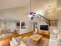 Spacious open-concept living room featuring a staircase, hardwood floors, and vaulted ceiling at 115 Sable Ridge Dr, Acworth, GA 30102