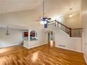 Spacious open-concept living room featuring a staircase, hardwood floors, and vaulted ceiling at 115 Sable Ridge Dr, Acworth, GA 30102