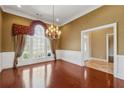 Elegant dining room featuring hardwood floors, large windows, and a decorative chandelier at 2850 Brandy Ln, Cumming, GA 30041