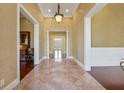 Grand foyer with stone tile flooring, elegant lighting, and views into adjacent rooms at 2850 Brandy Ln, Cumming, GA 30041
