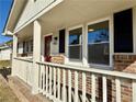Up-close view of the front porch featuring painted railings and brick accents at 1091 Mountain View Nw Rd, Conyers, GA 30012