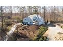 An aerial view of a home and spacious wooded lot at 210 Wrights Mill Way, Canton, GA 30115