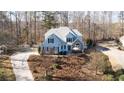 Beautiful home featuring blue siding, white trim, and a spacious front yard with mature trees at 210 Wrights Mill Way, Canton, GA 30115