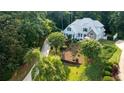 Lovely home with mature trees, lush landscaping, and a long driveway, offering picturesque curb appeal and privacy at 210 Wrights Mill Way, Canton, GA 30115