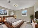 Cozy main bedroom featuring two windows, neutral walls, and a spacious layout at 4830 Shady Rest Dr, Powder Springs, GA 30127