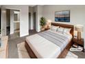 Relaxing primary bedroom with a king-size bed, cozy carpet, and ensuite bathroom at 507 N Gwinnett St, Buford, GA 30518