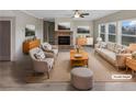 Bright, staged living room with neutral tones, a brick fireplace, and ample natural light at 507 N Gwinnett St, Buford, GA 30518