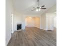 The open-concept living room features hardwood floors, a fireplace, ceiling fan, and lots of sunlight at 11139 Silver Aspen Ct, Hampton, GA 30228