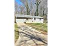 Charming single-story home with a gray exterior, a front porch, and a driveway at 2308 Baywood Se Dr, Atlanta, GA 30315