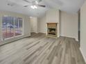 Bright living room featuring stylish gray floors and a fireplace with a mantle at 29 Saint James Pl, Sharpsburg, GA 30277