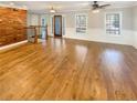 Spacious living room boasts gleaming hardwood floors, a decorative wood wall, and staircase to the upper level at 8014 Bells Ferry Rd, Canton, GA 30114