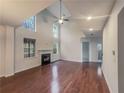 Living room offers vaulted ceilings, fireplace, and beautiful hardwood floors at 1156 Madison Green Sw Ln, Mableton, GA 30126