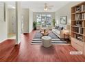 Bright, staged living room with modern decor, a striped rug, comfortable seating, and a view of the outdoors at 1485 Riverrock Trl, Riverdale, GA 30296