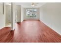 Spacious living room with rich flooring, offering ample natural light and a versatile space for decorating at 1485 Riverrock Trl, Riverdale, GA 30296
