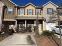 Charming townhome featuring a welcoming entryway, a private garage, and beautiful landscaping at 1970 Old Dogwood, Jonesboro, GA 30238