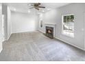 Spacious living room featuring a fireplace, neutral carpet, recessed lighting, a ceiling fan, and bright windows at 4565 Bridle Point Pkwy, Snellville, GA 30039