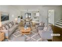 Bright and airy living room featuring modern decor, hardwood floors, and seamless transition to the dining area at 5407 Effingham Ct, Lithonia, GA 30038