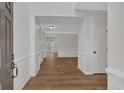 Bright foyer with hardwood floors and crisp white moldings that lead to an open concept living area at 1235 King Springs Se Ct, Smyrna, GA 30080