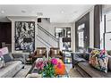 Bright living room with stylish decor, comfortable seating, and a staircase leading to the upper level at 3475 Landen Pine Ne Ct, Atlanta, GA 30305