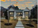 Beautiful home with a stone walkway and manicured lawn under a colorful sunset at 372 Karen Dr, Alpharetta, GA 30009