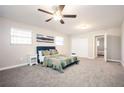 Spacious bedroom featuring a ceiling fan, large windows and a queen sized bed at 1887 King Charles Sw Rd, Atlanta, GA 30331