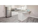 Bright kitchen featuring stainless steel appliances, white cabinetry, and granite countertops at 1887 King Charles Sw Rd, Atlanta, GA 30331