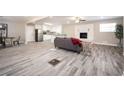 Open-concept living area with wood-look flooring, fireplace, and seamless transition to the kitchen at 1887 King Charles Sw Rd, Atlanta, GA 30331