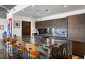 The kitchen features a large granite island with bar seating, sleek wood cabinets, and stainless steel appliances at 845 Spring Nw St # 502, Atlanta, GA 30308