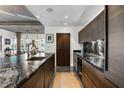 Beautiful kitchen with a granite island, wood cabinets, and stainless steel appliances with dining and living area background at 845 Spring Nw St # 502, Atlanta, GA 30308