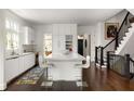 Bright kitchen featuring a large center island with seating, sleek white cabinetry, and hardwood floors, perfect for modern living at 895 Inman Village Ne Pkwy, Atlanta, GA 30307