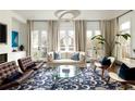 Elegant living room with natural light, stylish furniture, and a chic rug creating a welcoming and sophisticated atmosphere at 895 Inman Village Ne Pkwy, Atlanta, GA 30307