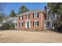 Red brick two-story home with black shutters and a well-kept front lawn on a sunny day at 1030 Eulalia Ne Rd, Atlanta, GA 30319