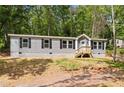 Charming home with gray siding, black shutters and a well-manicured lawn, perfect for suburban living at 160 Vandiver Rd, Canton, GA 30114