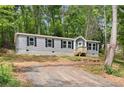 Inviting home with a well-maintained lawn and charming wood porch, perfect for relaxed outdoor enjoyment at 160 Vandiver Rd, Canton, GA 30114
