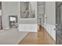 Inviting entryway with hardwood floors, wainscoting, and a staircase leading to the upper level at 1384 Stone Bay Sw Dr, Atlanta, GA 30331