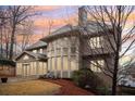 Beautiful view of the home exterior highlighting the ample windows and wooded backyard at 1884 Point River Dr, Duluth, GA 30097